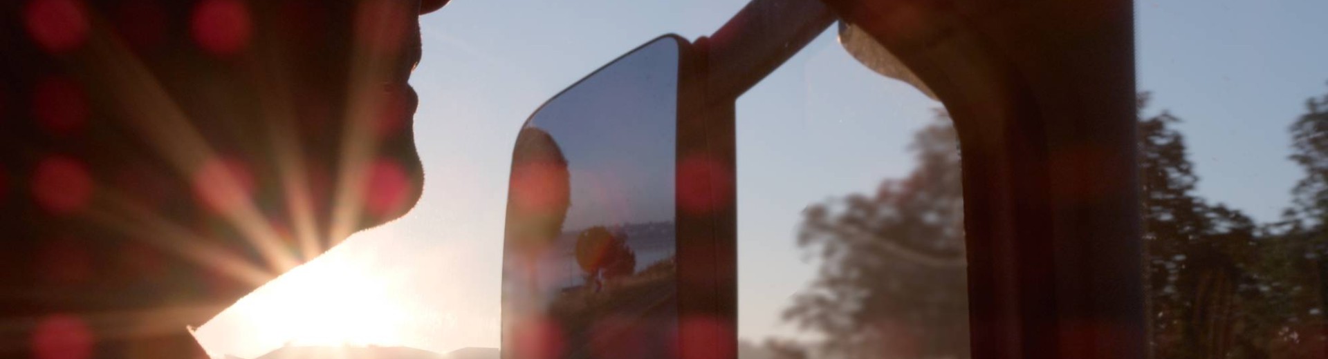 Driver in a trailer cabin at sunset